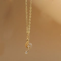 Macro shot of gold treble clef musical note pendant necklace with white zircon stones - Large Music Note XL3262-5