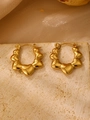 Elegant gold heart-shaped hoop earrings with polished finish on a stone surface - 18K Gold Heart Hoop (1282)