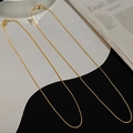 Detail shot of a minimalist double-layered gold snake chain necklace with glossy texture - Two Pieces Gold Round Snake Chain