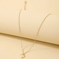 Detailed close-up of golden heart pendant necklace with decorative disc chain and smooth finish - Gold Heart Necklace