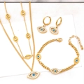 Elegant gold jewelry set with blue devil eye pendants and sparkling crystals - Three-Piece Set