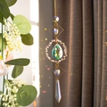 Detail of crystal suncatcher with golden metal frame and pink beads reflecting light - Rose Quartz Circle