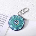 Detailed close-up of a large Bohemian Evil Eye keychain with blue mandala geometric patterns - Circle of Eyes