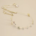Detail view of golden headband with rhinestone butterflies and long tassel chain - Gold Purple Crystal