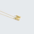 Golden necklace with letter N pendant featuring small white pearls on a white background - Letter N