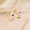 Detail of 18K gold hoop earrings featuring light purple enamel and evil eye charms - Light Purple