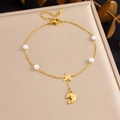 Detail of gold starfish and dolphin pendants with pearls on a steel anklet chain - Starfish & Dolphin Pearl Style (B1698)