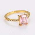 Close-up of golden ring with pink emerald-cut gemstone and small pave-set diamonds - US 7 / Gold/Light Pink Zircon