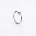 Detail of C-shaped stainless steel nose ring with sparkling round cubic zirconia stud - Silver
