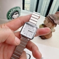 Detail shot of a square quartz watch with silver metallic expansion band on wrist - Silver/White