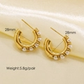 Elegant 28mm golden C-shaped hoop earrings with white pearls on satin background - Pearl Row C-Shape Earrings