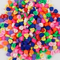 Close-up of colorful heart-shaped polymer clay beads with LOVE text for DIY jewelry - Love Heart