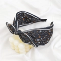 Detail of bohemian black cashew print fabric headband with a large bow decoration - Dark Grey Paisley Print Bow Headband