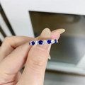 Macro shot of S925 sterling silver ring with blue and clear gemstones on a hand - US 6 / Blue & White