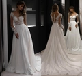 Detailed back view of long sleeve lace wedding dress with sheer embroidery and buttons - US 2 / Ivory
