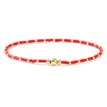 Macro shot of handmade red disc beads and gold metal spacers on this bohemian bracelet - Dark Red