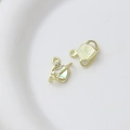 Macro detail of gold heart planet pendants with zircon and iridescent shell inlay - Style 7
