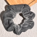 Macro shot of grey velvet scrunchie showing detailed texture and soft pleated fabric - Gray