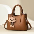 Brown lychee-textured leather handbag with a plush smiley pendant and shoulder strap - Khaki/Earth Yellow