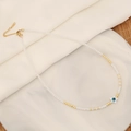 Macro shot of evil eye star pendant with white beaded chain and golden extension - Star Shape