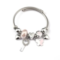 Detail view of silver charm bracelet with pink butterfly, heart key, and glass beads - Pink