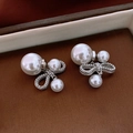 Detailed macro shot of elegant bow pearl earrings with polished gold-plated finish - Silver Bowknot Pearl