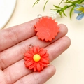 Pair of red resin daisy pendants with yellow centers and metal loops for DIY jewelry - Red