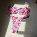 Detailed flat lay of floral bandeau bikini set with starfish and seashell on textured mat - S / Pink Floral