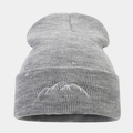 Close-up of grey knitted beanie featuring detailed mountain peak embroidery on the cuff - Light Gray