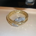 Close-up of golden snake bangle with crystal pavé details on head and tail - Bracelet-Gold