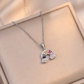 Macro detail of rainbow zircon pendant with pavé clouds on a silver-tone chain - Rainbow Necklace / Silver