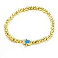 Close-up of golden beaded bracelet featuring a blue enamel star-shaped pendant detail - Sky Blue