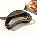 Detail of amber translucent resin hair claw clip with crescent curve design on white surface - 12cm Moon - Jelly Dark Grey