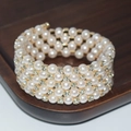 Detail of four-row pearl bracelet with sparkling rhinestones and gold metal finish - 5 Rows Gold