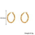 Gedetailleerde weergave van 35mm gouden gedraaide oorringen met gewichtsspecificatie - 35mm / Goud