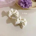 Detail view showing a 5.3cm white satin bow hair claw clip for a sweet princess hairstyle - Single Piece / White