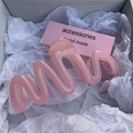 Pink wavy hair claw clip in jelly texture presented on premium gift packaging paper - Jelly Pink