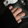Irregular wavy metal ring with two green gemstones on finger in a minimalist style - No. 51 Open Ring