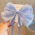 Close-up of a light blue organza bow hair clip with flowing ribbons and sheer texture - Mermaid Blue