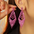 Sparkling pink rhinestone geometric fringe drop earrings worn by a model in close-up view - Rose Red