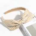 Detailed macro view showing beige and white woven straw texture and bow on the headband - Woven Beige