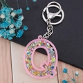 Pink acrylic letter Q keychain with colorful star sequins and silver metal lobster clasp - Letter Q
