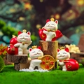 Four lucky cat figurines with festive symbols like red fish and gold coins for wealth - Festive Set of 4