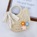 Detailaufnahme der Strohhandtasche mit Spitzenschleife und bunten 3D-gestrickten Blumen - Drei Häkelblumen-Beige