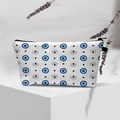 Waterproof white toiletry bag featuring blue evil eye pattern on a geometric display stand - 20-White Blue Pupil Dots