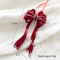 Red velvet Christmas bow pendant with gold glitter edges and festive hanging ribbon - Bow