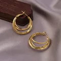 Elegant gold multi-layer triple hoop earrings with a polished metallic finish - Three-Layer Circular Design / E-067---Gold