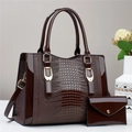 Brown crocodile embossed tote bag and wallet set with glossy finish on white surface - Coffee Brown