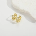 Macro shot of gold chain earrings with micro-paved white zircons on a white background - White Zirconia Hollow Style (ES2639)