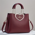 Detail of burgundy heart-shaped gold buckle with always love you engraving and litchi texture - Red